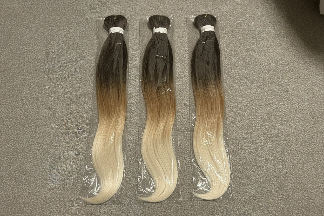 Packaged hair extension with gradient color on a textured surface